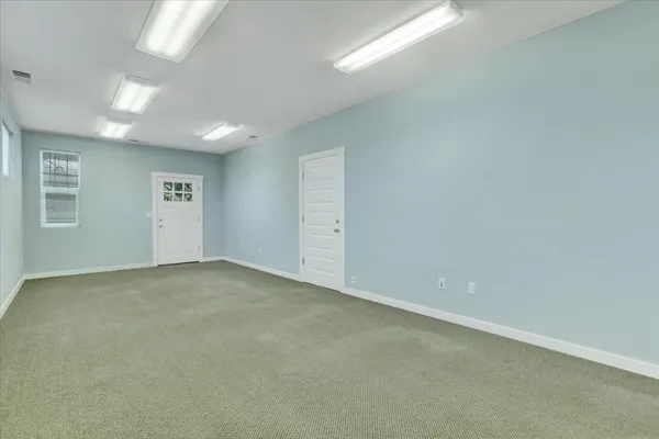 a view of a backyard with potted plants and wooden fence