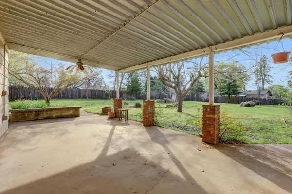 a view of a field of grass and trees