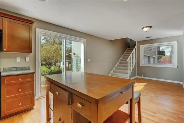 an empty room with a window and chandelier fan