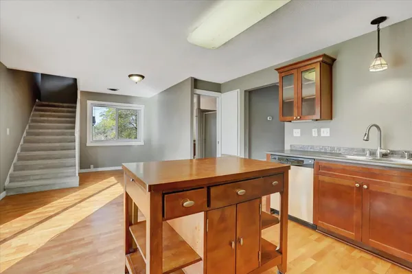 a bathroom with a granite countertop sink a toilet and a mirror