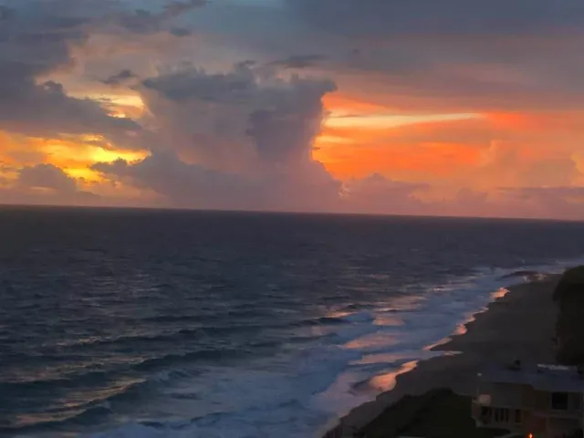 a view of living room with furniture and large window