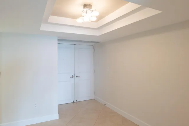 a large white kitchen with stainless steel appliances kitchen island granite countertop a sink and cabinets
