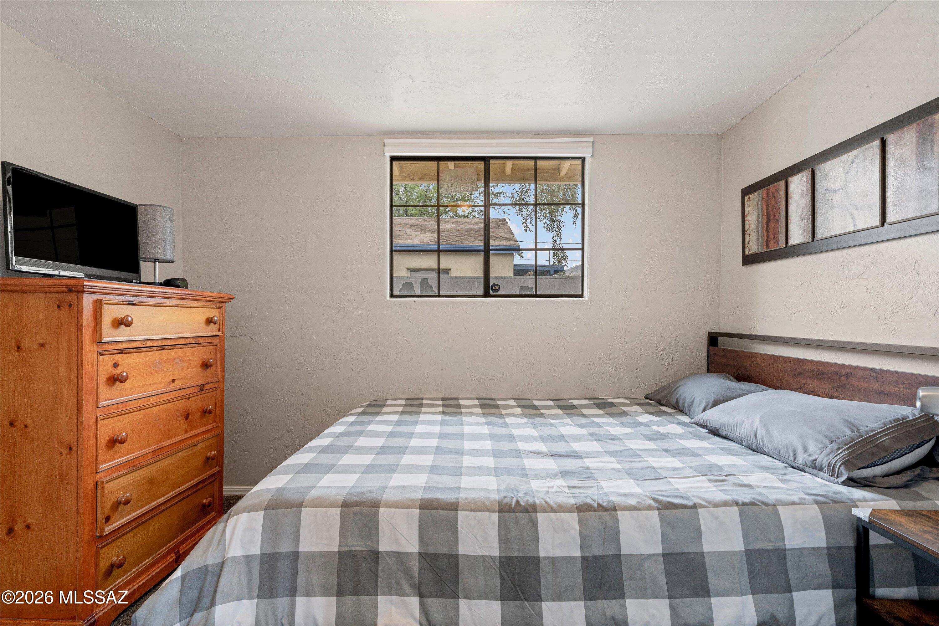 2841 North Richey Boulevard Tucson, AZ 85716 - Photo 20 of 30 a bedroom with a bed and flat screen tv