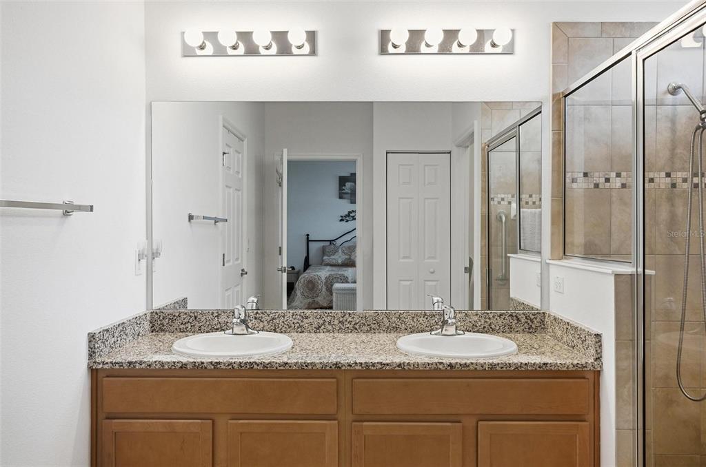 2 Tideway Trail Palm Coast, FL 32137 - Photo 18 of 34 a bathroom with a granite countertop sink and a mirror