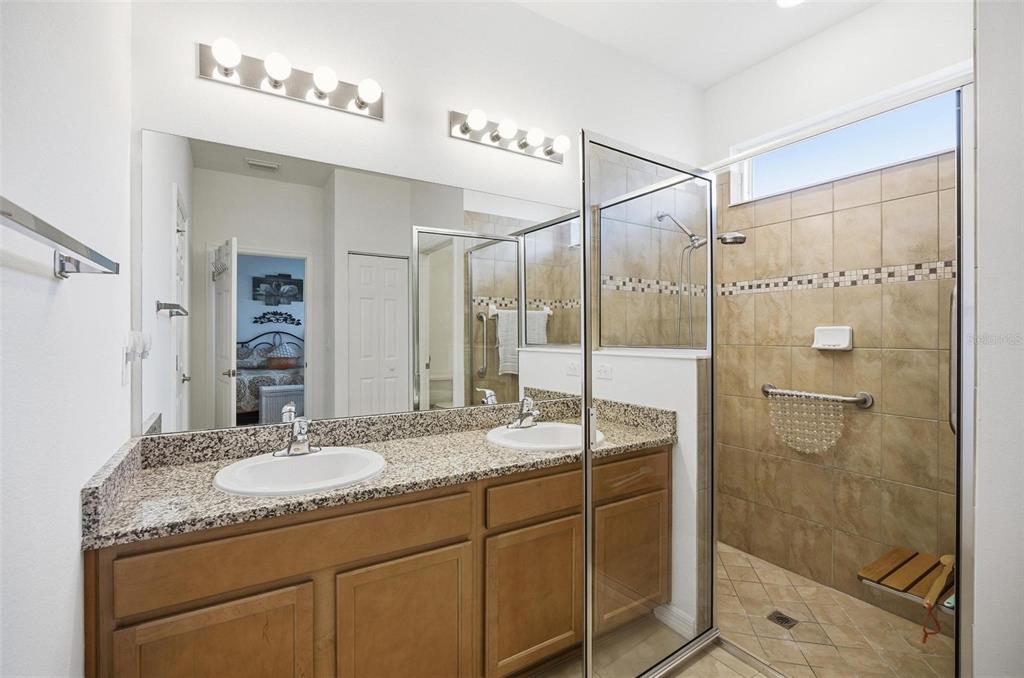 2 Tideway Trail Palm Coast, FL 32137 - Photo 19 of 34 a bathroom with a granite countertop sink a mirror and shower