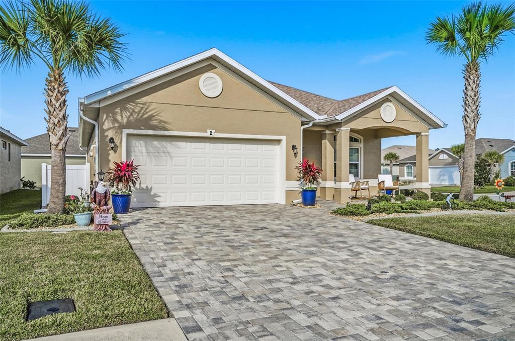 2 Tideway Trail Palm Coast, FL 32137 - Photo 2 of 34 a front view of a house with a yard and garage