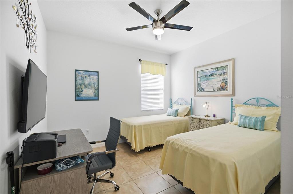 2 Tideway Trail Palm Coast, FL 32137 - Photo 25 of 34 a bedroom with two beds and a desk