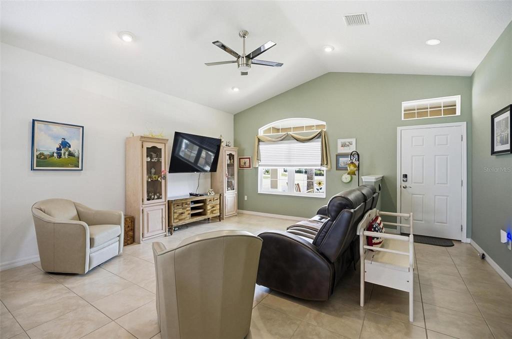 2 Tideway Trail Palm Coast, FL 32137 - Photo 7 of 34 a living room with furniture and a flat screen tv