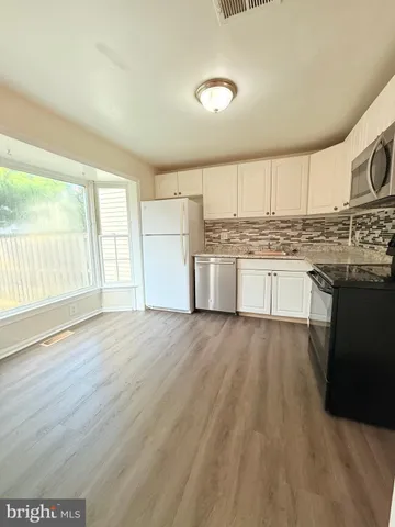 a kitchen with stainless steel appliances granite countertop a stove and a sink