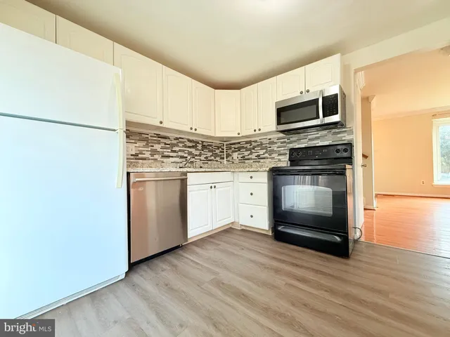 a kitchen with stainless steel appliances a refrigerator sink and microwave