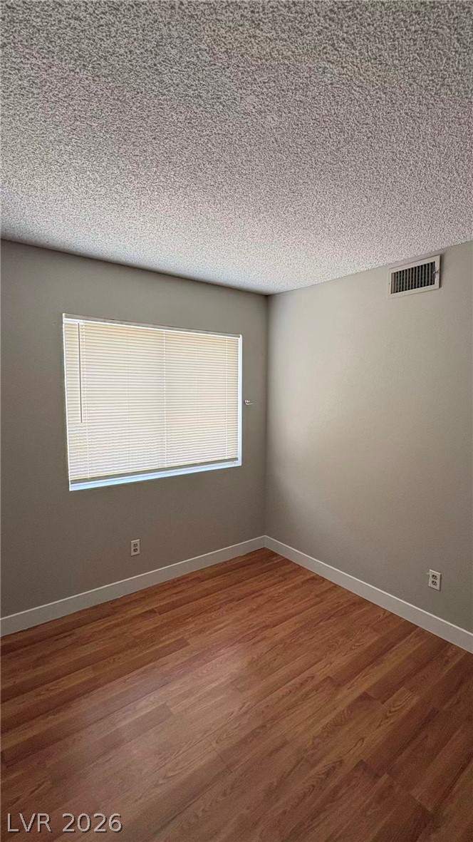 4325 Newcastle Road Las Vegas, NV 89103 - Photo 13 of 18 Hardwood-style flooring and natural light create a welcoming and comfortable space.