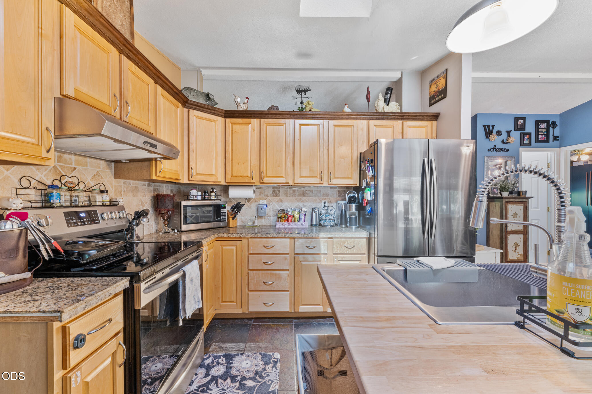 690 Foots Creek Road Gold Hill, OR 97525 - Photo 15 of 45 a kitchen with stainless steel appliances granite countertop a refrigerator a sink dishwasher a stove and white countertops with wooden floor