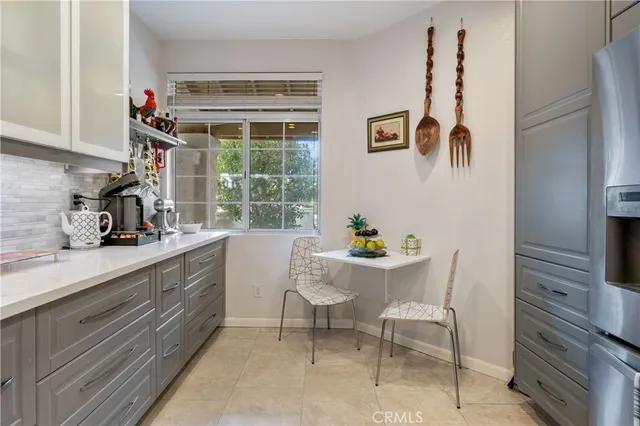 a kitchen with a refrigerator and a sink