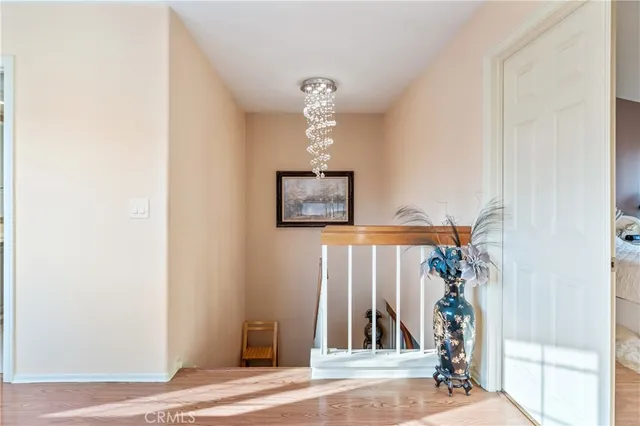 a view of a hallway with entryway wooden floor and front door