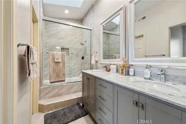 a bathroom with a granite countertop sink mirror and double