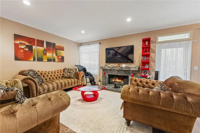 a living room with furniture a fireplace and a flat screen tv