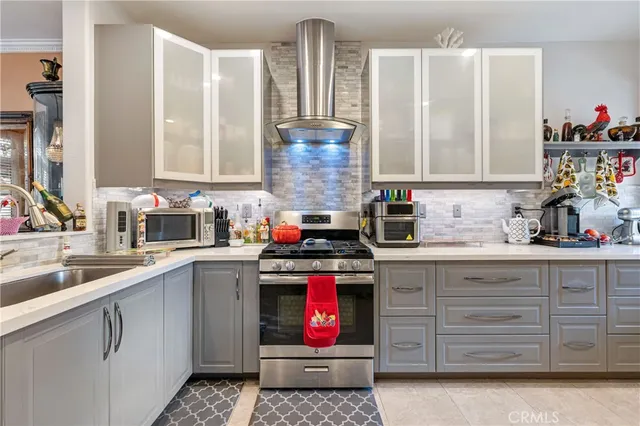 a kitchen with granite countertop a sink stainless steel appliances and cabinets