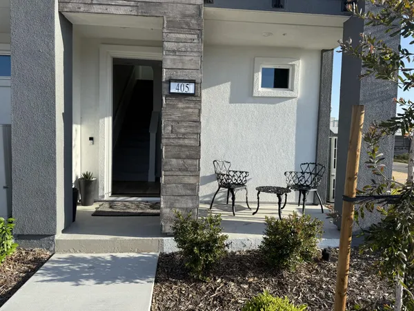 a view of a door with a bench and table and chair