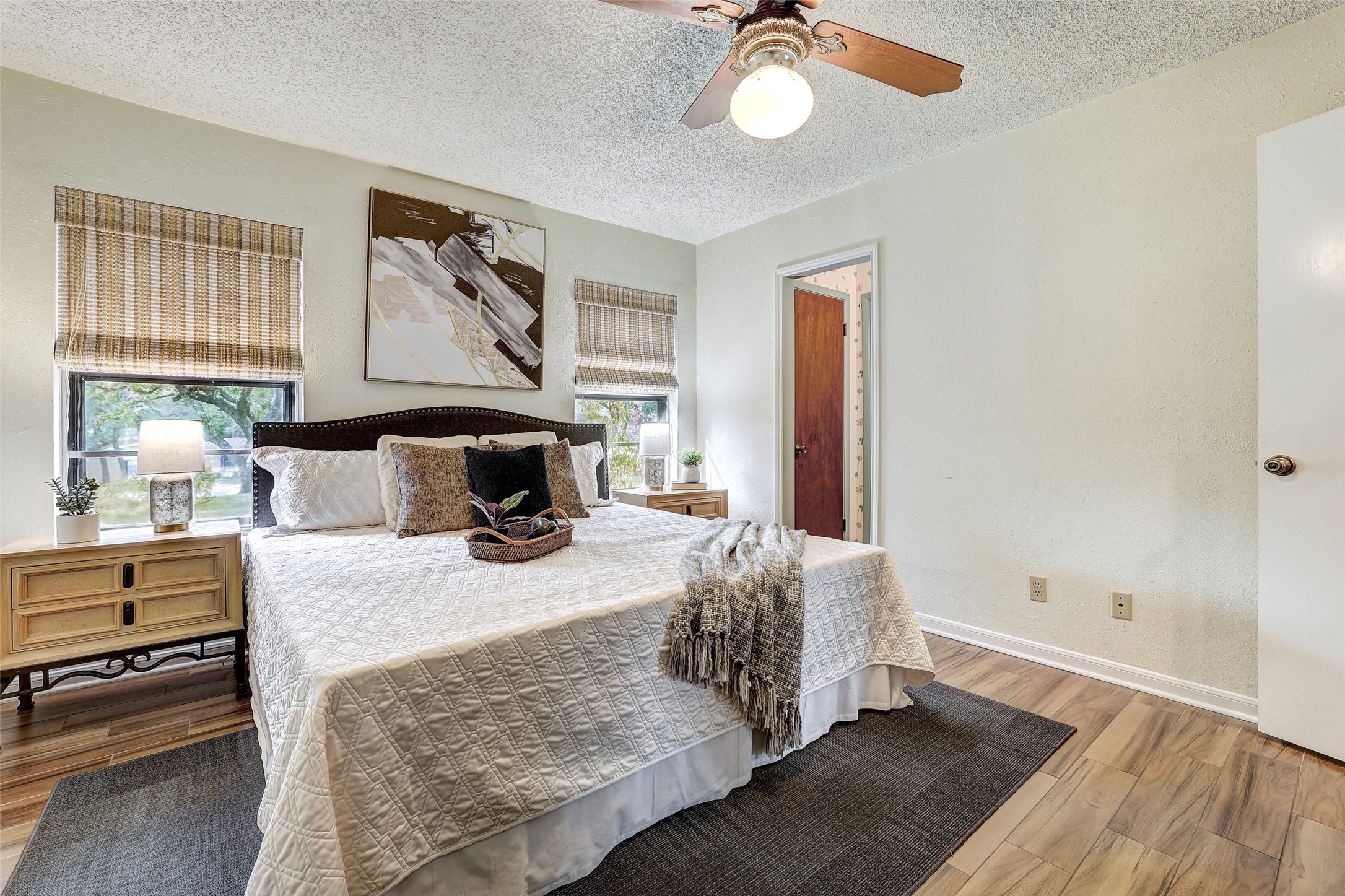 8606 Thunderbird Road, Unit A & B Austin, TX 78736 - Photo 16 of 29 Bedroom with a textured ceiling, ceiling fan, and wood finished floors