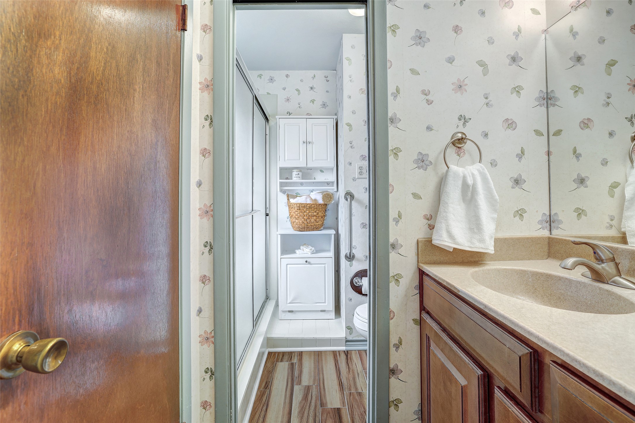 8606 Thunderbird Road, Unit A & B Austin, TX 78736 - Photo 19 of 29 Full bathroom with wallpapered walls, vanity, a stall shower, and light wood finished floors