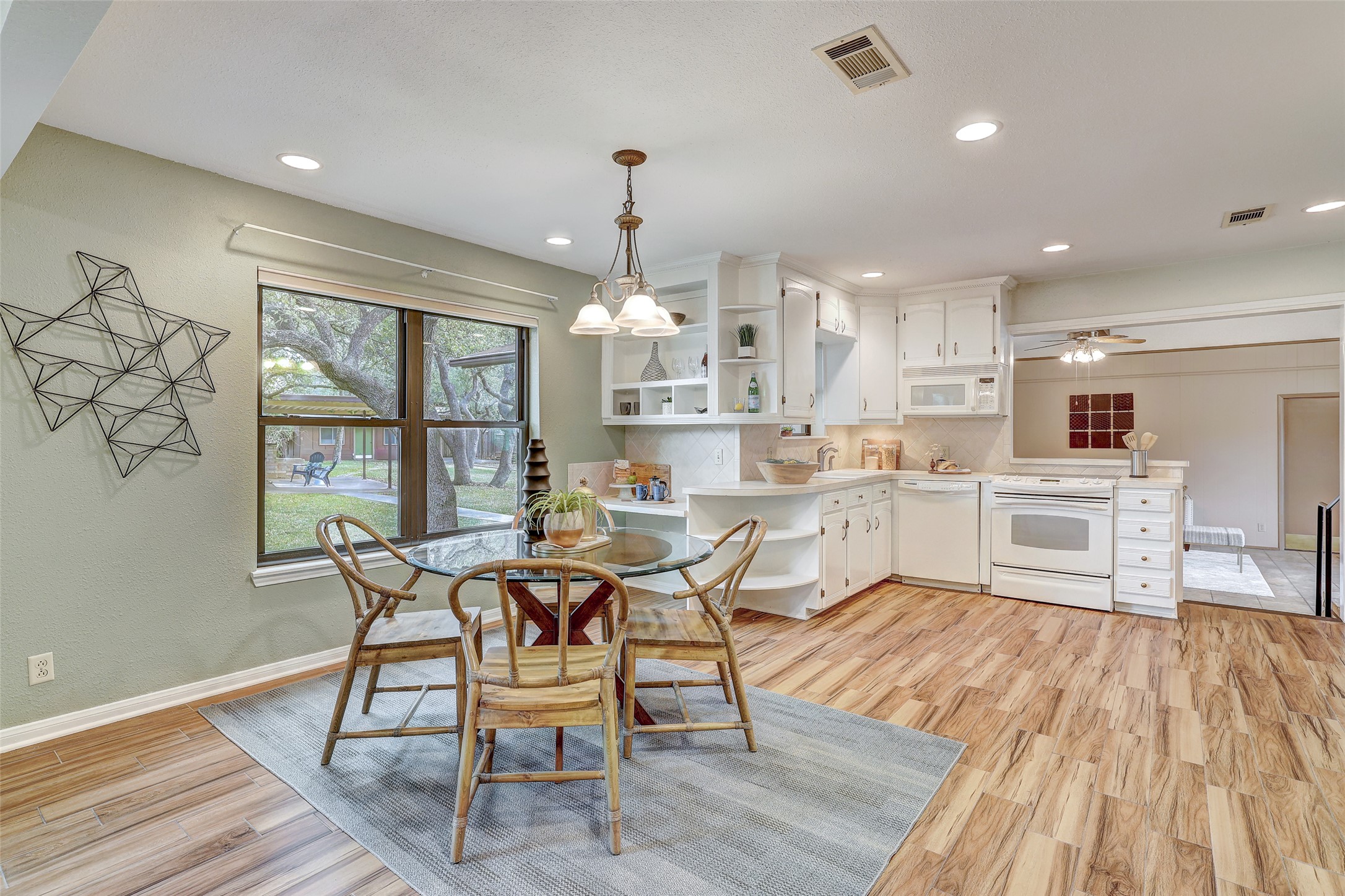 8606 Thunderbird Road, Unit A & B Austin, TX 78736 - Photo 6 of 29 Dining area featuring light wood-style floors, recessed lighting, and a ceiling fan, windows facing private backyard