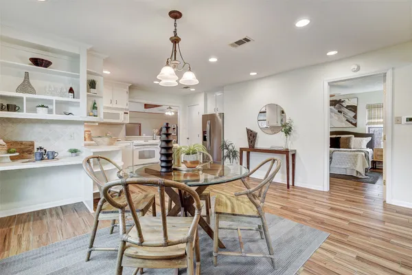 a view of a dining room with furniture and wooden floor
