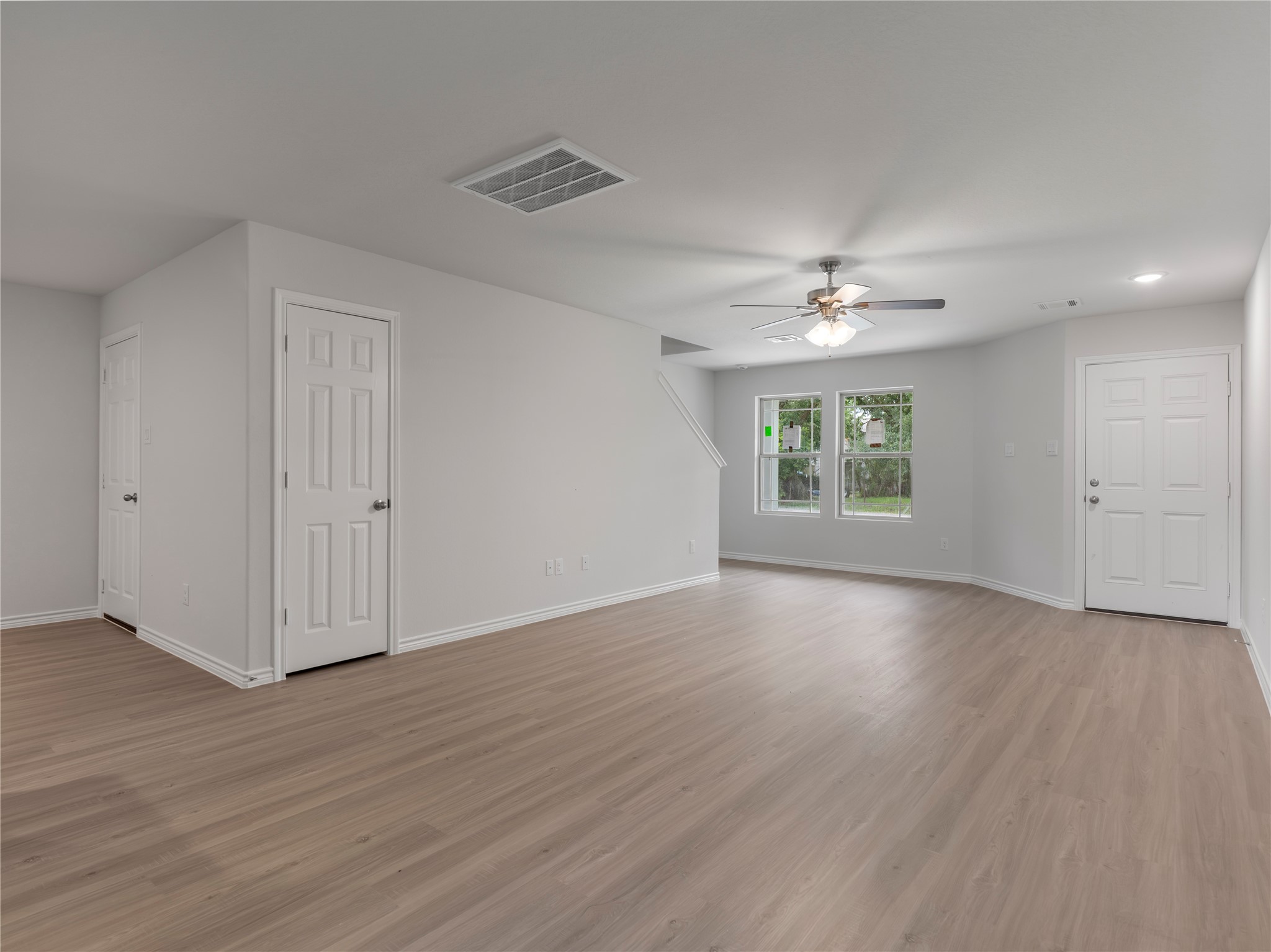 306 North Orange Street Sweeny, TX 77480 - Photo 8 of 30 Spacious living area with a modern ceiling fan, perfect for comfort and relaxation.