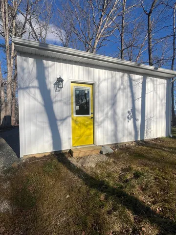 a view of a backyard with a large tree