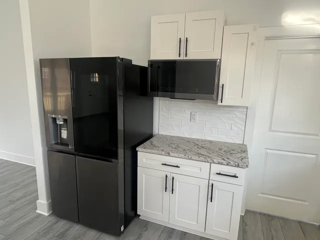 a kitchen with stainless steel appliances granite countertop white refrigerator and cabinets