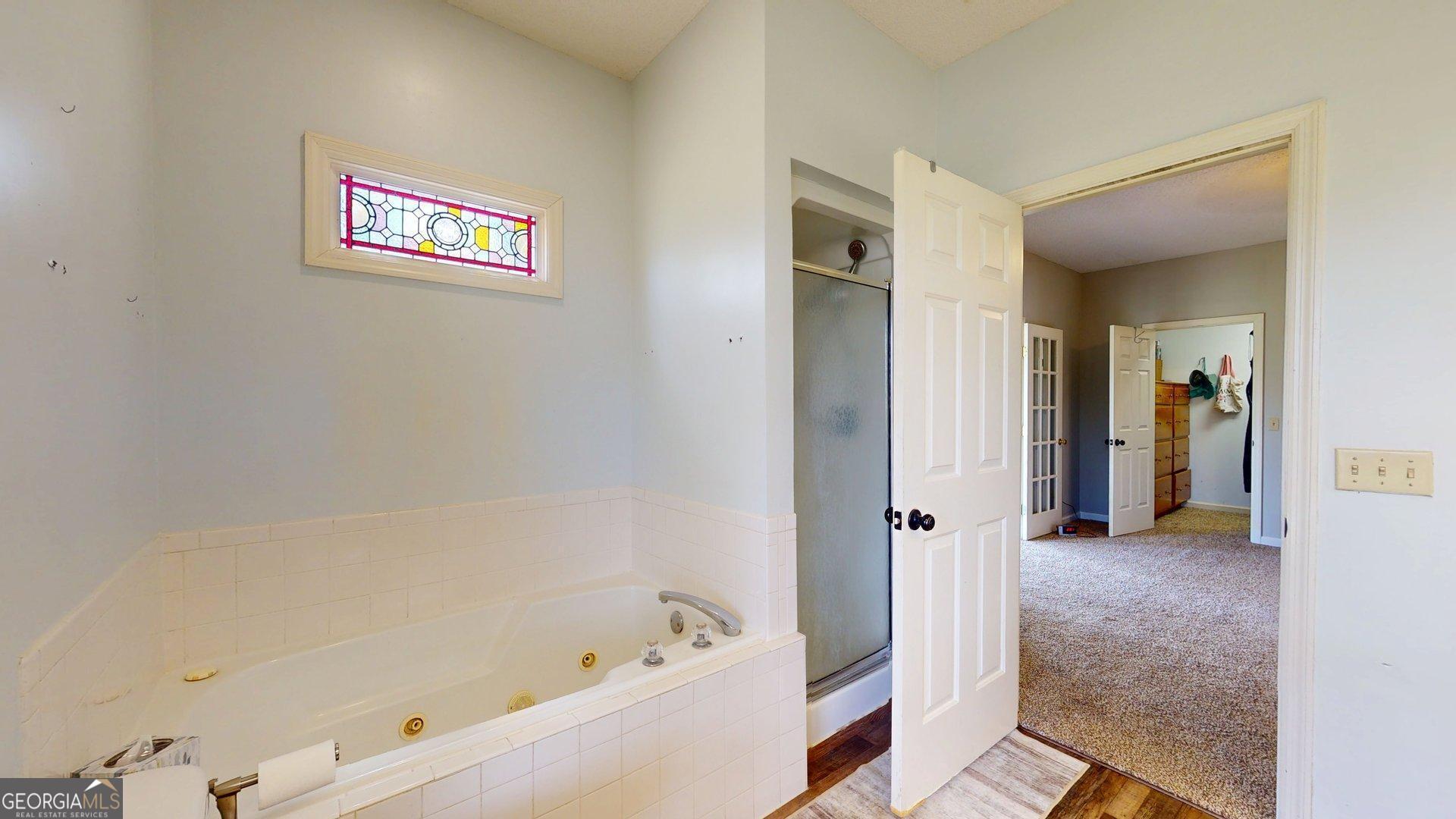 1717 Grady Saunders Road Portal, GA 30450 - Photo 27 of 41 a bathroom with a bathtub and a shower