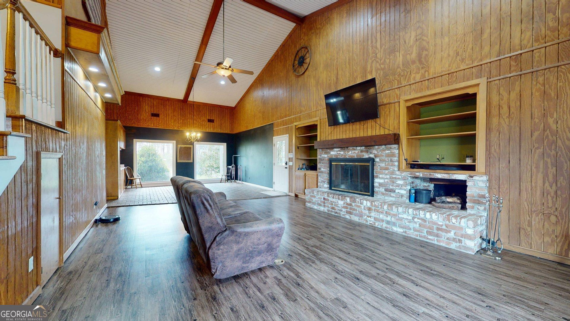 1717 Grady Saunders Road Portal, GA 30450 - Photo 5 of 41 a living room with fireplace furniture and a flat screen tv