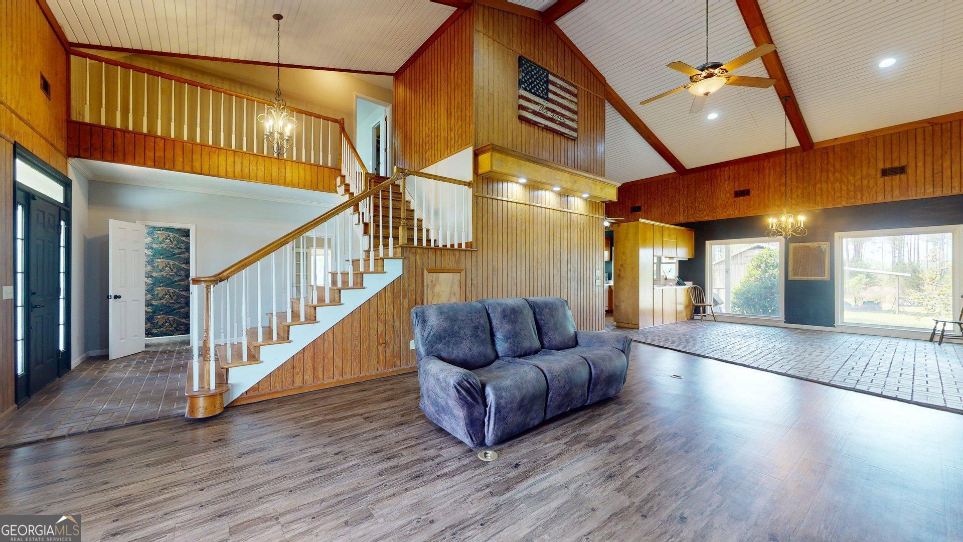 1717 Grady Saunders Road Portal, GA 30450 - Photo 8 of 41 a hallway with couches and large windows with wooden floor