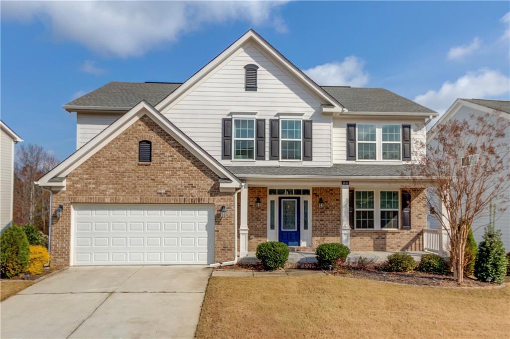 a front view of a house with a yard and garage