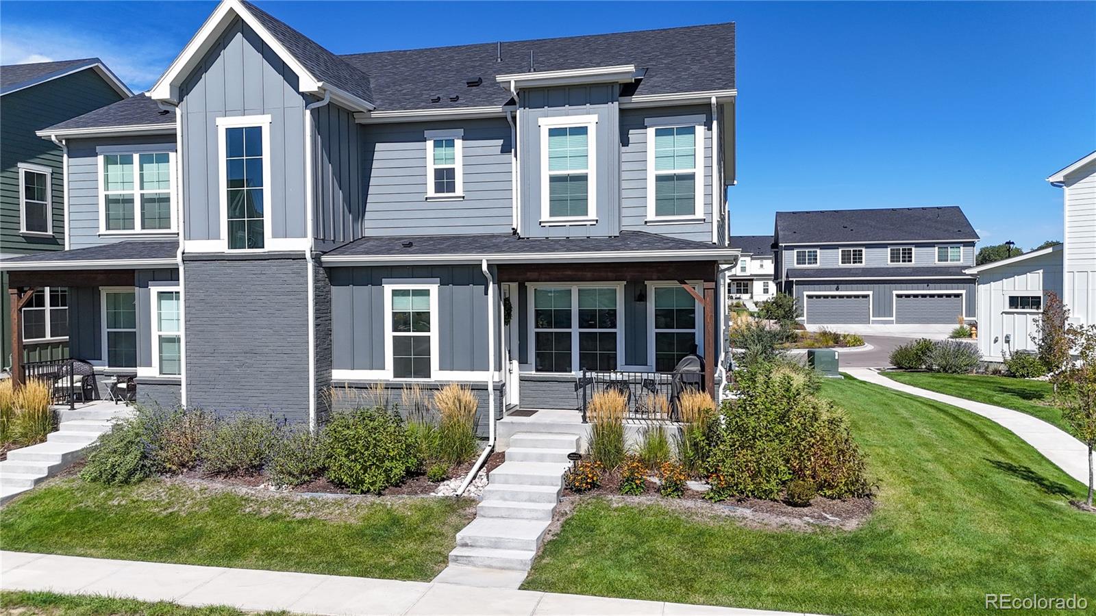 front view of a brick house with a yard