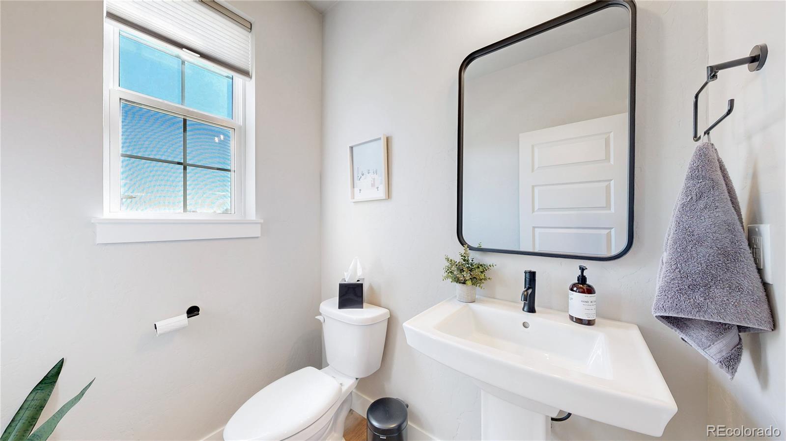 275 Dipper Court Berthoud, CO 80513 - Photo 11 of 34 a bathroom with a sink mirror and toilet