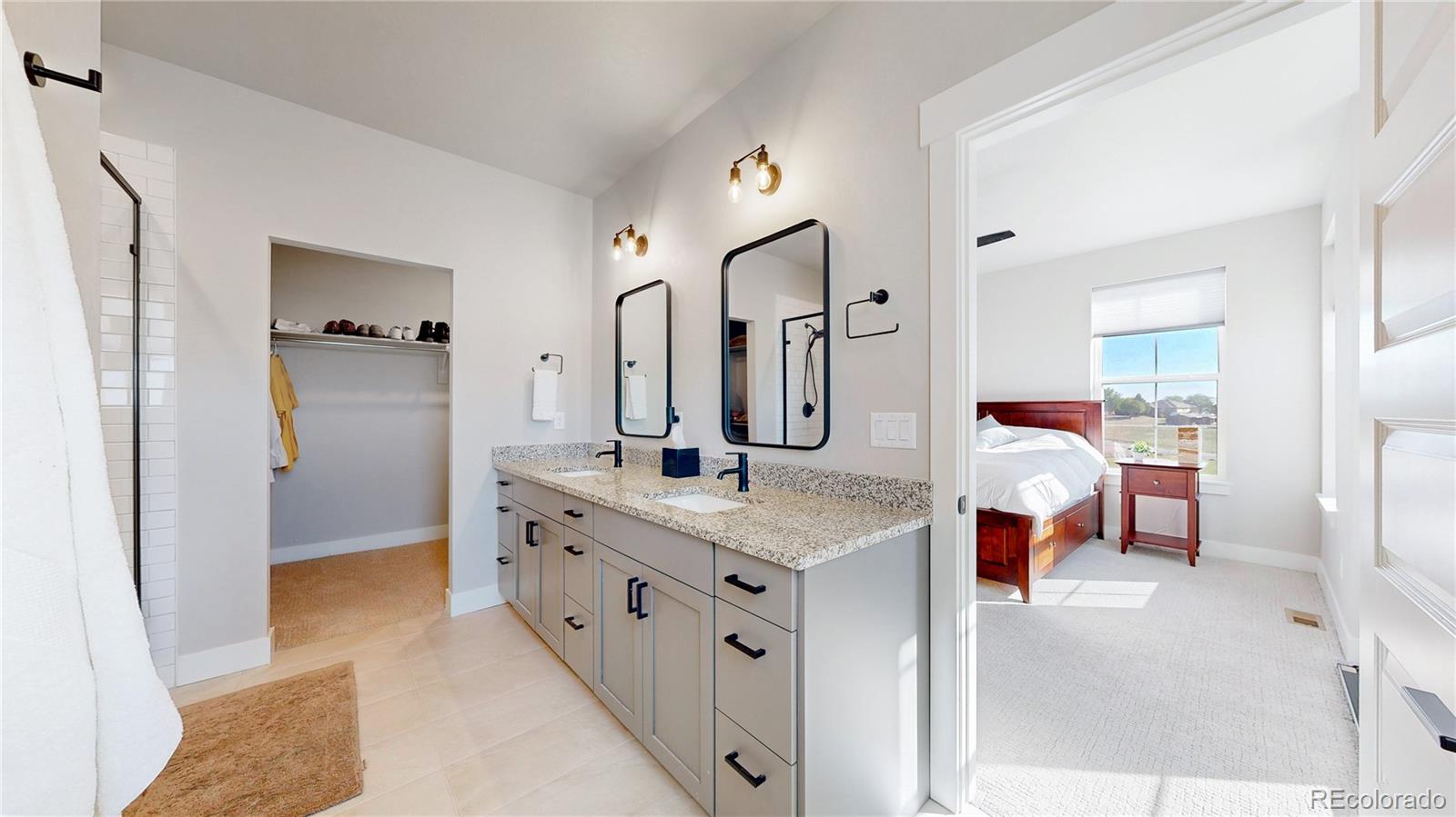 275 Dipper Court Berthoud, CO 80513 - Photo 14 of 34 a spacious bathroom with a double vanity sink mirror and shower