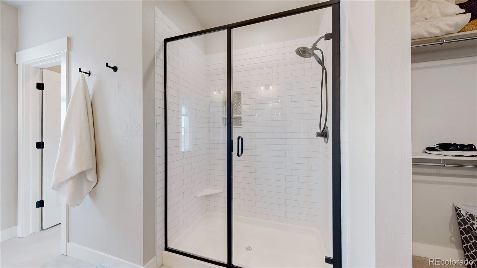 275 Dipper Court Berthoud, CO 80513 - Photo 16 of 34 a bathroom with a shower and a glass door
