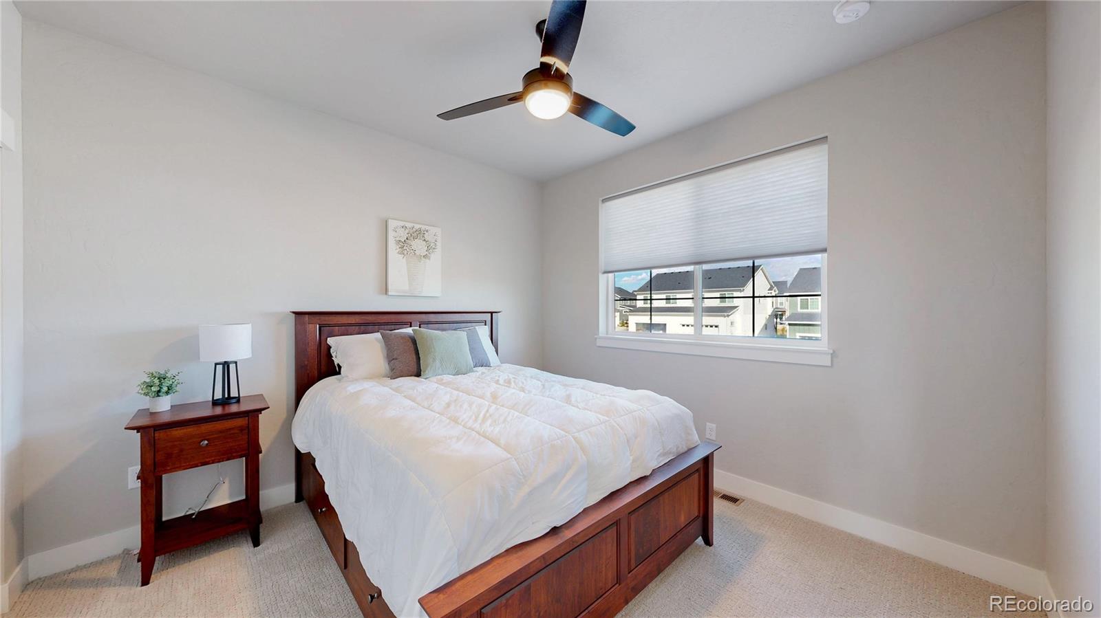275 Dipper Court Berthoud, CO 80513 - Photo 17 of 34 a bedroom with a bed and a chandelier