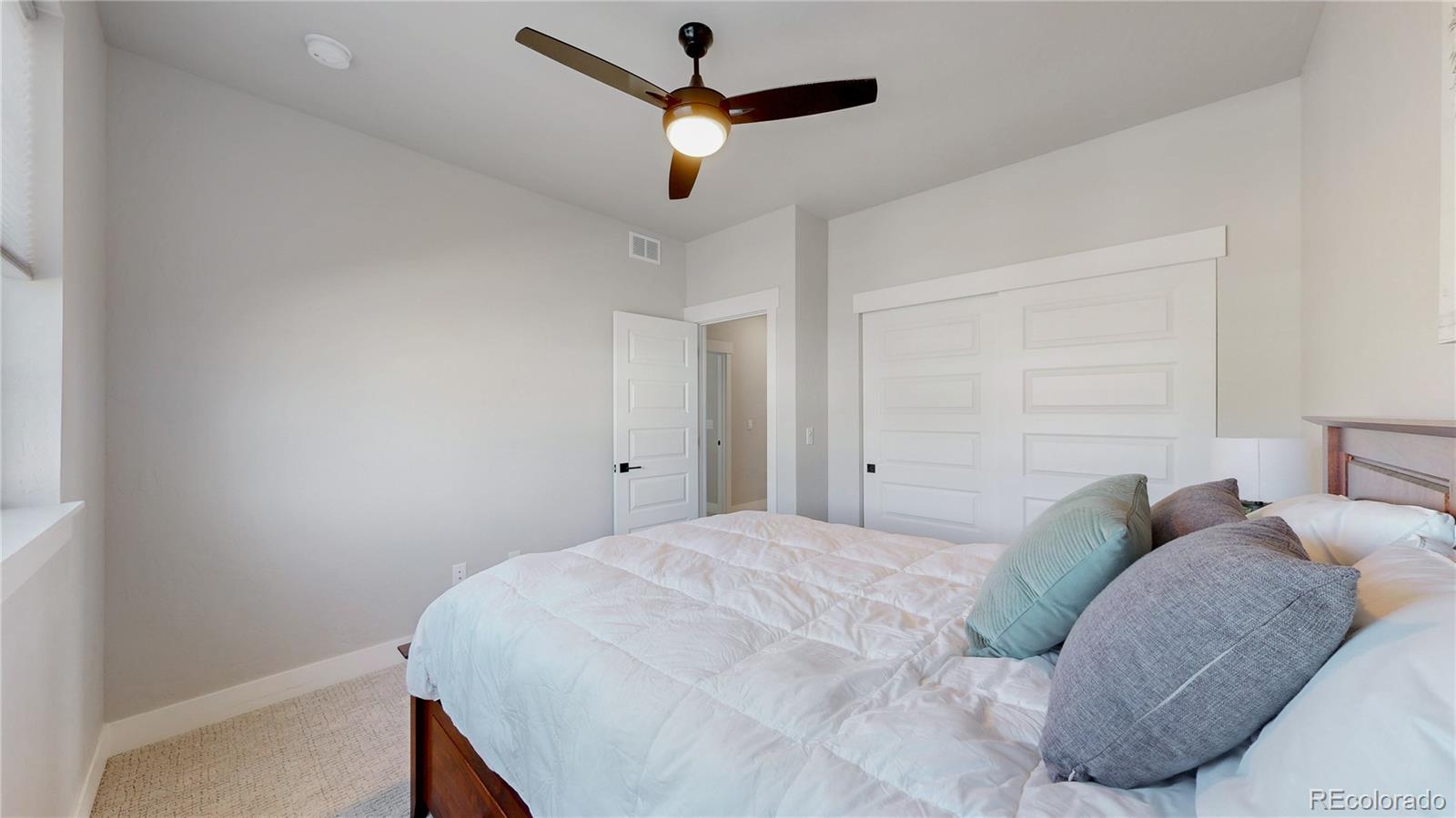 275 Dipper Court Berthoud, CO 80513 - Photo 18 of 34 a bedroom with a bed and a ceiling fan