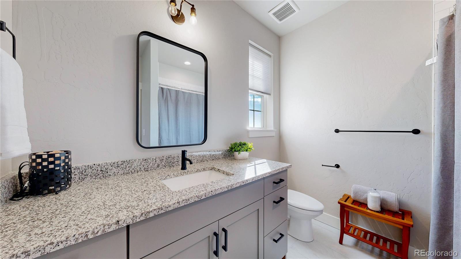 275 Dipper Court Berthoud, CO 80513 - Photo 21 of 34 a bathroom with a toilet sink and mirror