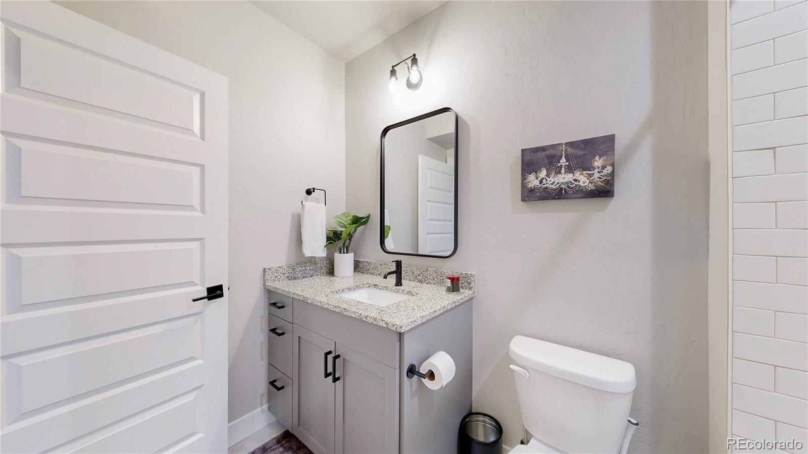 275 Dipper Court Berthoud, CO 80513 - Photo 22 of 34 a bathroom with a toilet a sink and mirror
