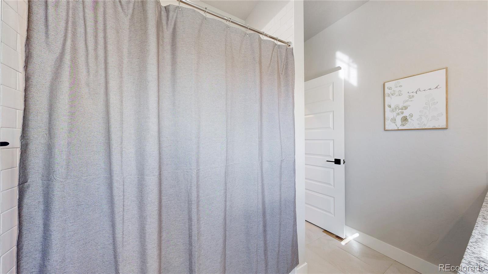 275 Dipper Court Berthoud, CO 80513 - Photo 23 of 34 a view of a bathroom with shower curtain