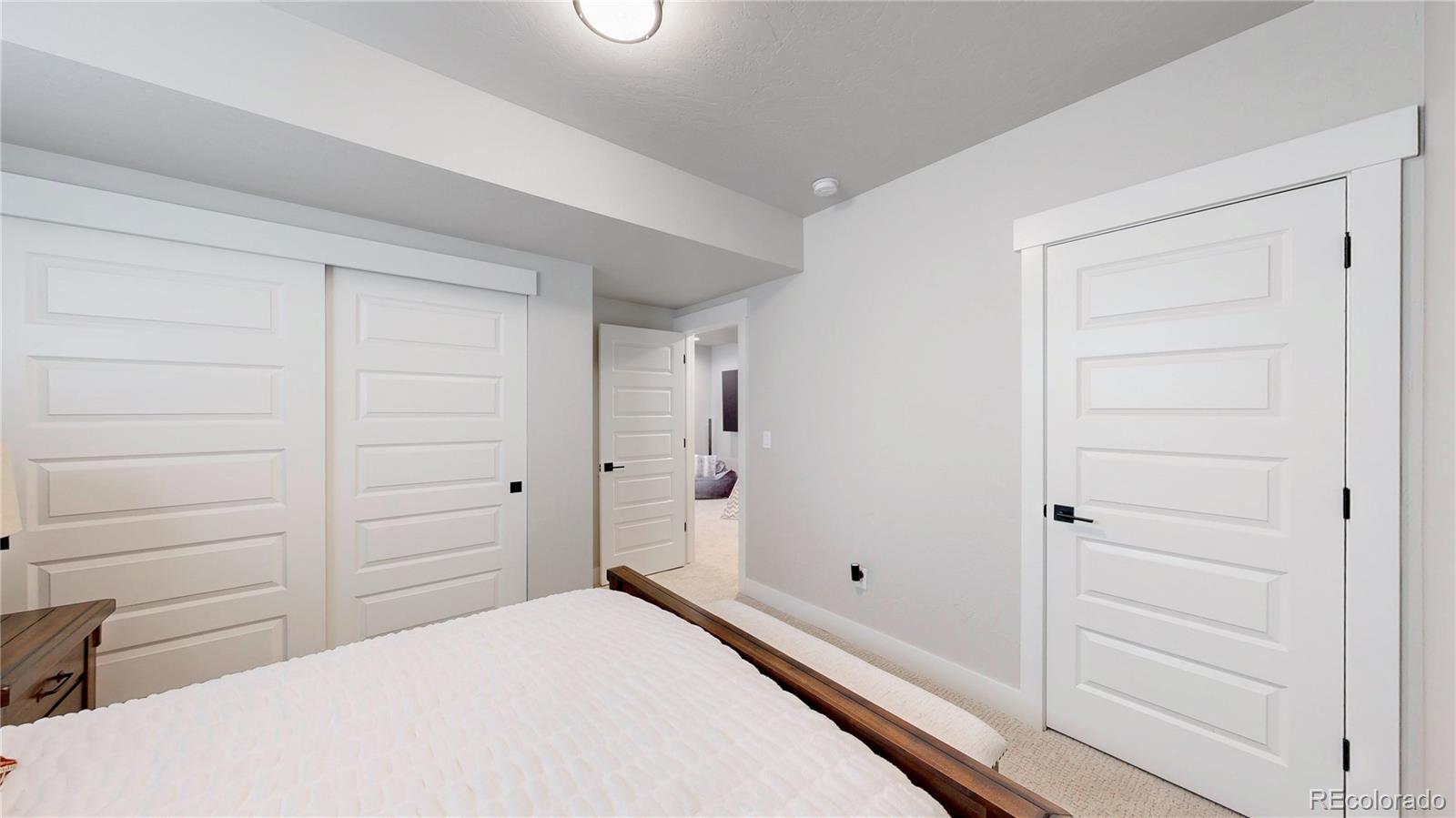 275 Dipper Court Berthoud, CO 80513 - Photo 27 of 34 a bedroom with a closet and a cabinet