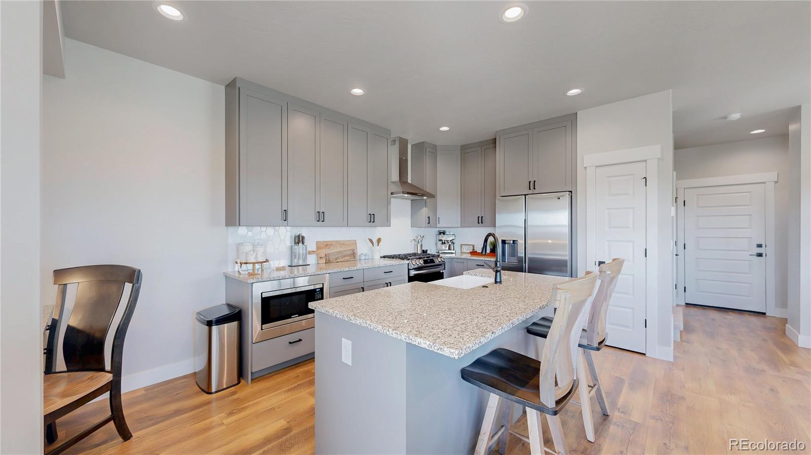 275 Dipper Court Berthoud, CO 80513 - Photo 5 of 34 a view of kitchen with cabinets and wooden floor
