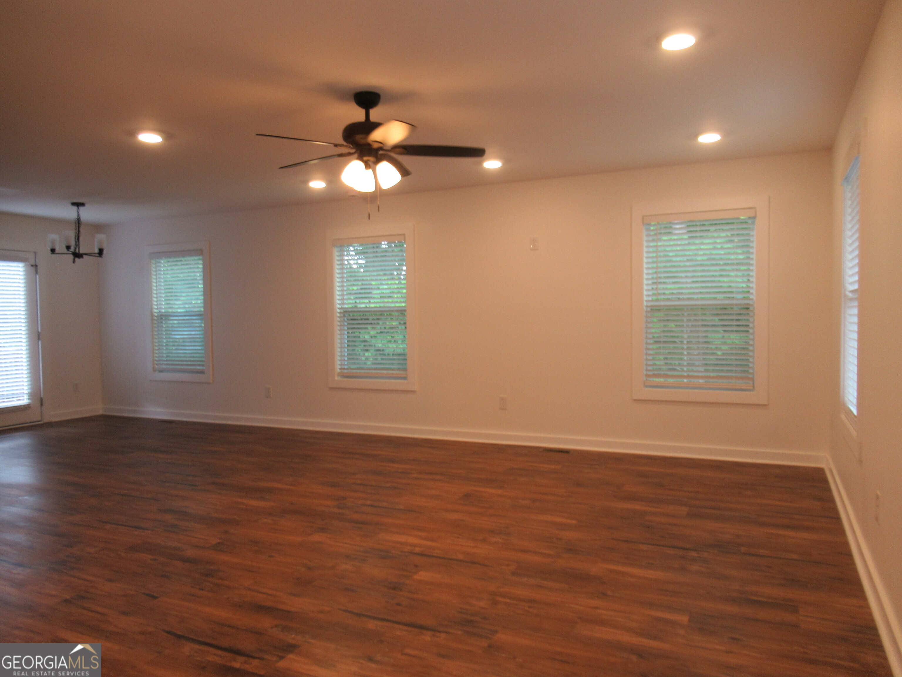 765 Old Kerns Road Dawsonville, GA 30534 - Photo 5 of 36 a view of an empty room with wooden floor and a window