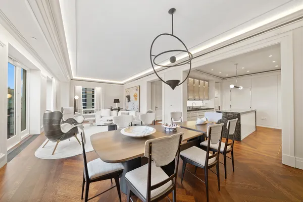 a living room with furniture a large window and glass door