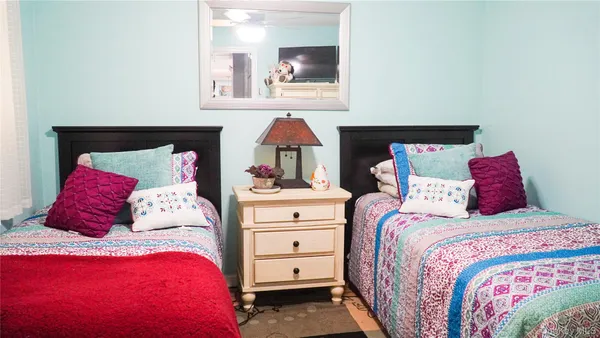 a bed room with a bed and a painting on the wall