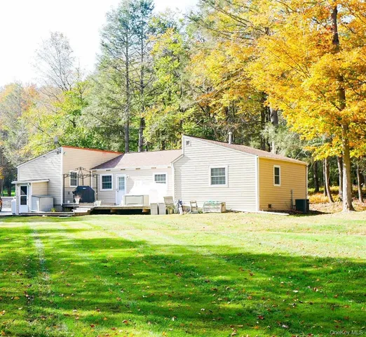 a bathroom with a toilet and a mirror