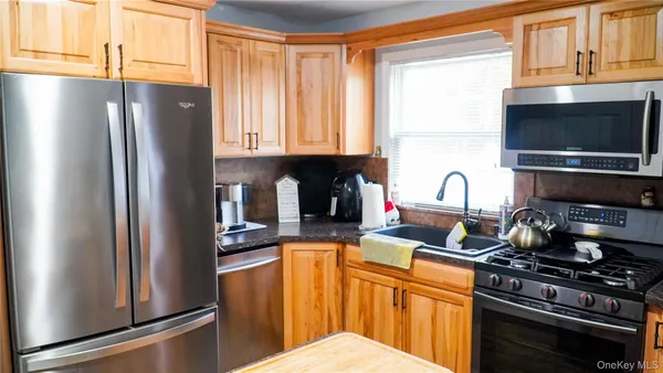 a kitchen with stainless steel appliances granite countertop a refrigerator stove and sink