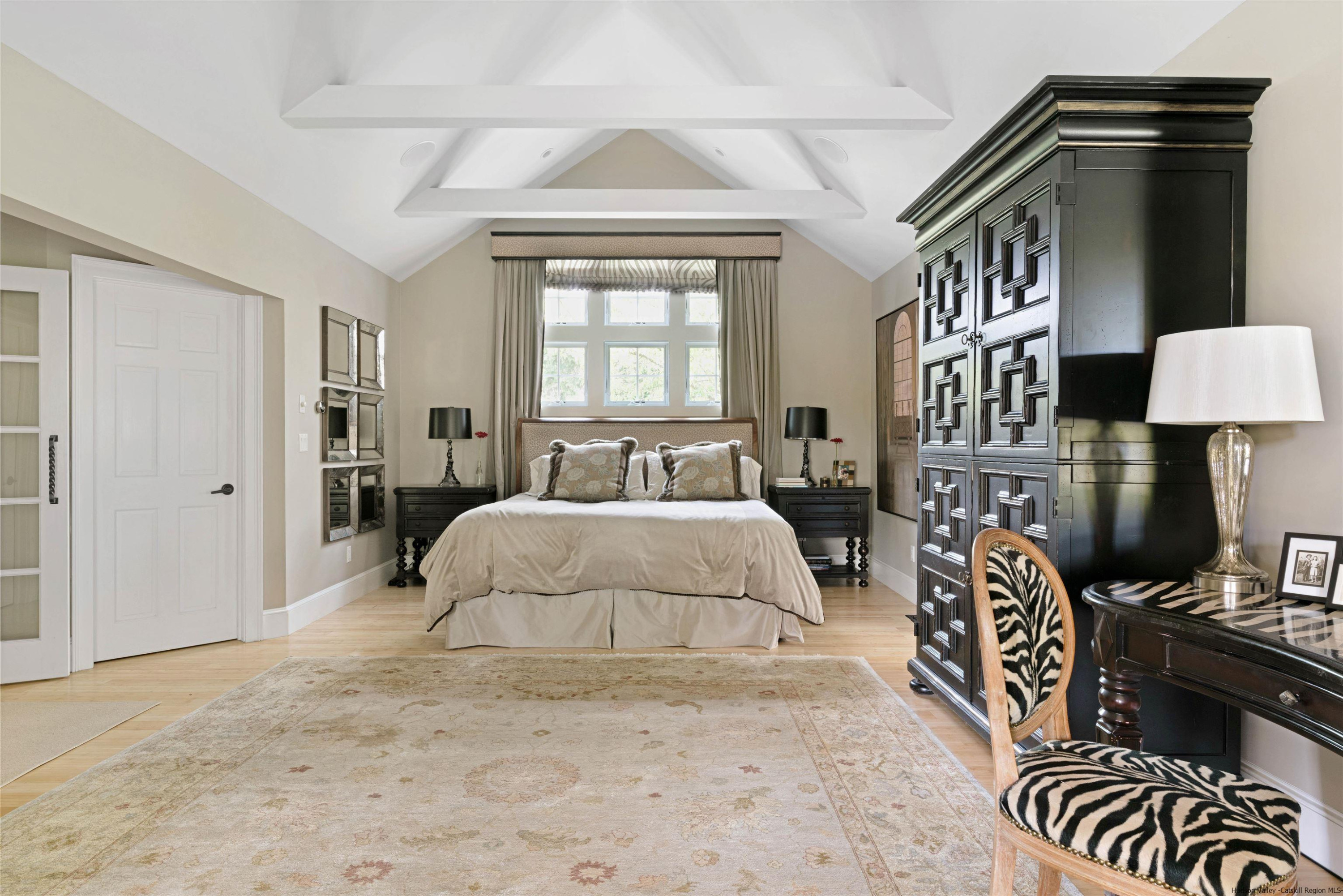 42 Union Center Road Ulster Park, NY 12487 - Photo 18 of 35 a spacious bedroom with a bed and a lamp